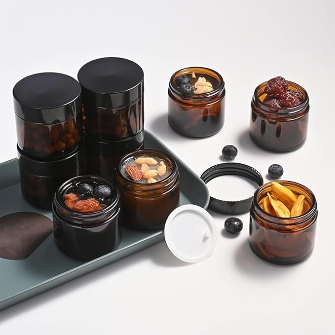 2 oz Round Amber Glass Jars, Bumobum 70 pack Cream Jars with Black Lids, Black and White Labels & Inner Liners, Empty Cosmetic Containers for Cream, Lotion